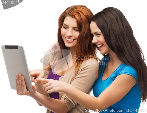 Image of two smiling teenagers with tablet pc computer