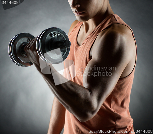 Image of young man with dumbbell