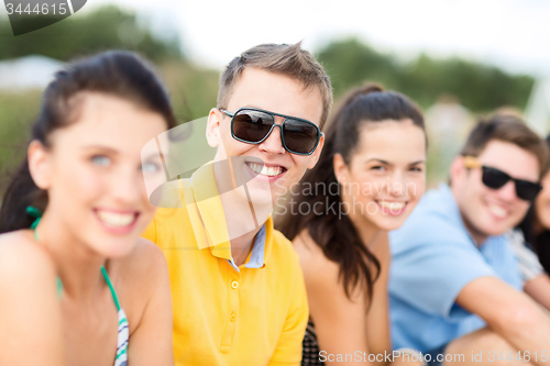 Image of group of happy friends on beach