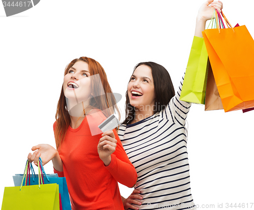 Image of teenage girls with shopping bags and credit card