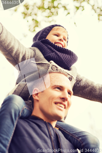 Image of happy family having fun in autumn park