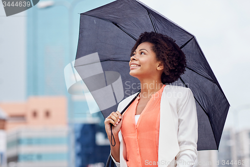 Image of happy african american businesswoman with umbrella