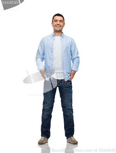 Image of smiling man with hands in pockets