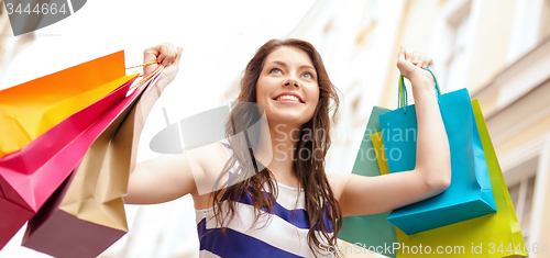 Image of beautiful woman with shopping bags in the ctiy