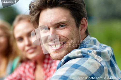 Image of group of smiling friends outdoors
