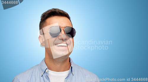 Image of face of smiling man in shirt and sunglasses