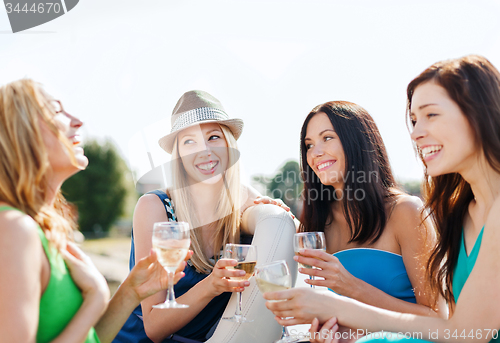 Image of girls with champagne glasses on boat