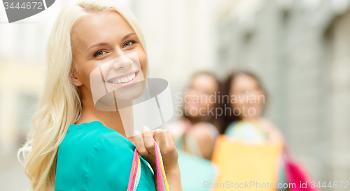 Image of beautiful woman with shopping bags in the ctiy