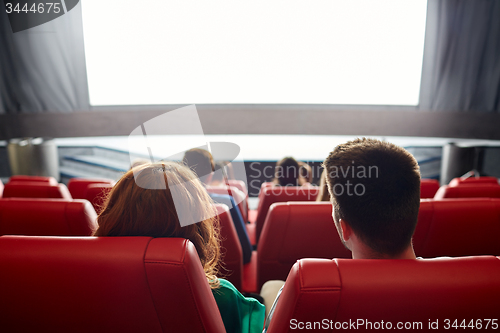 Image of happy couple watching movie in theater or cinema