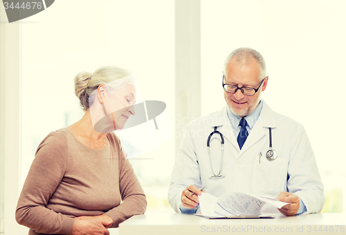 Image of smiling senior woman and doctor meeting