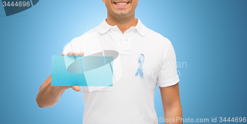 Image of man with prostate cancer awareness ribbon and card