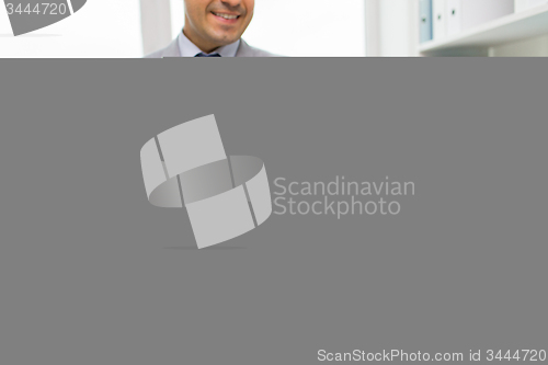 Image of close up of businessman with laptop and papers