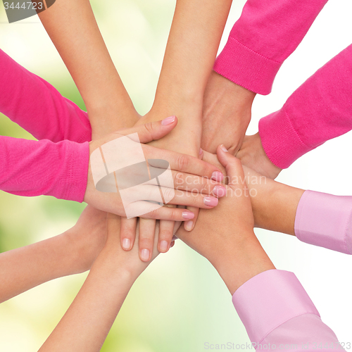 Image of close up of women with hands on top