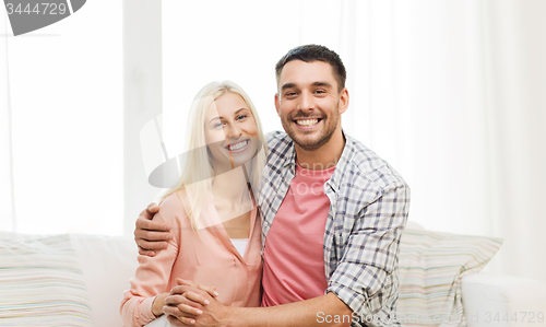 Image of smiling happy couple at home