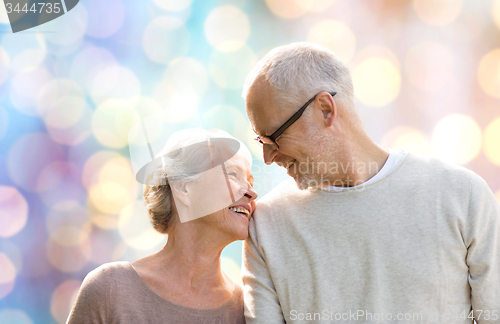 Image of happy senior couple over holidays lights