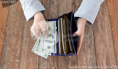 Image of close up of woman hands with wallet and money