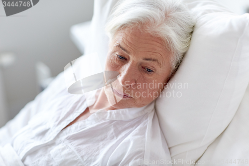 Image of senior woman patient lying in bed at hospital ward