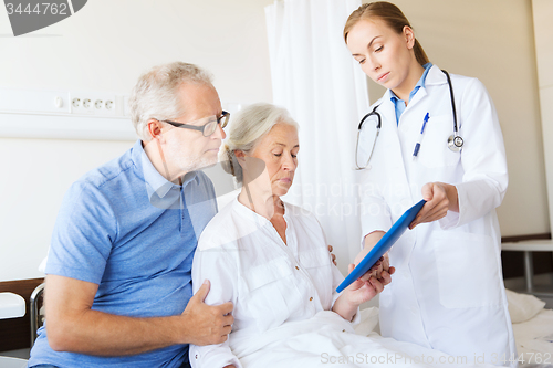 Image of senior woman and doctor with tablet pc at hospital