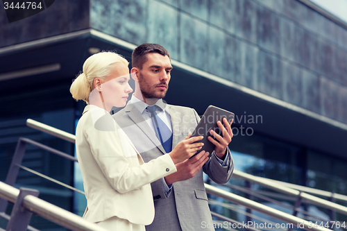 Image of businesspeople with tablet pc outdoors