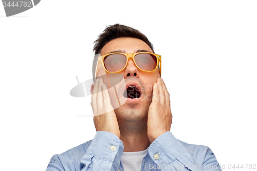 Image of face of scared man in shirt and sunglasses