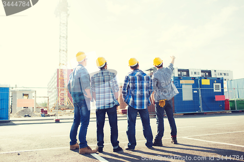 Image of group of builders in hardhats outdoors