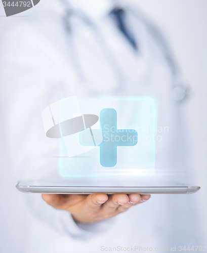 Image of male doctor holding tablet pc with medical app