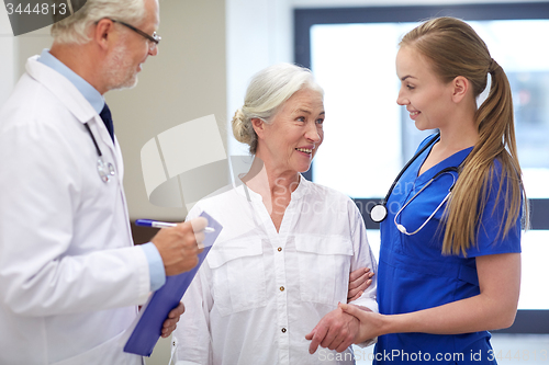 Image of medics and senior patient woman at hospital