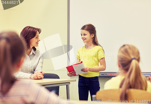 Image of group of school kids with teacher in classroom