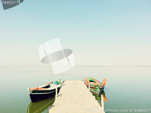 Image of Calm lake with two fishing boats