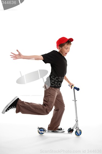 Image of Happy boy riding a scooter