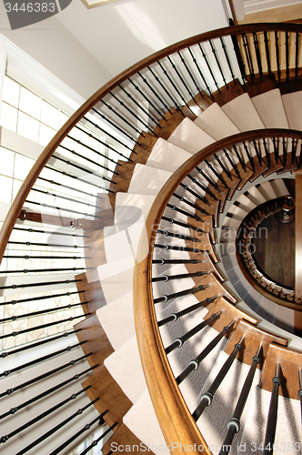 Image of Closeup of a round staircase over three floor\'s