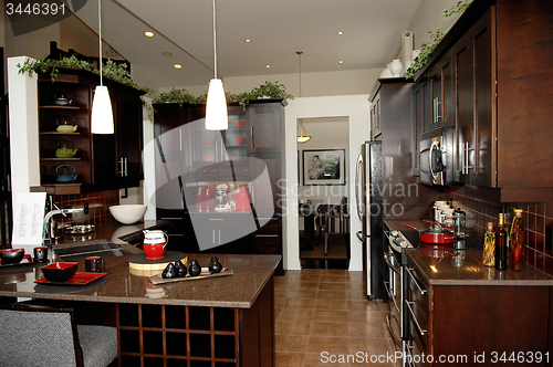 Image of Gorgeous kitchen with dark wood finish.