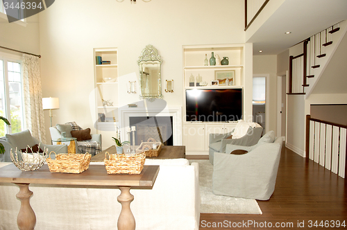 Image of Living room with fireplace and stairs.