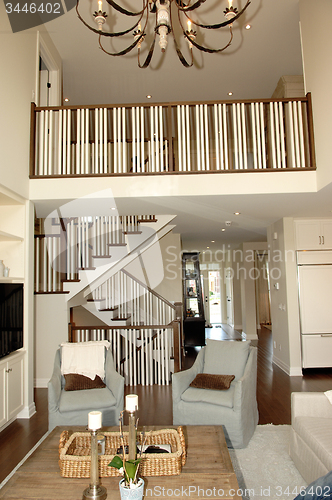 Image of Elegant roomy living room with staircase.