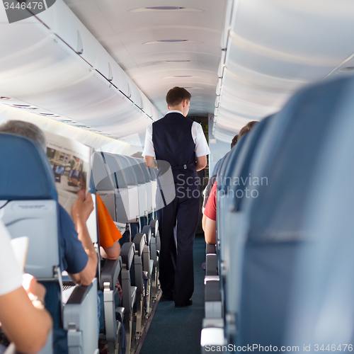 Image of Steward on the airplane.