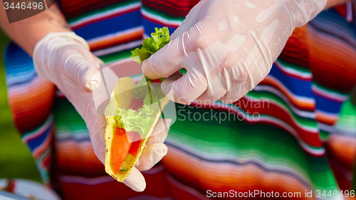 Image of Chef making tacos at a street cafe