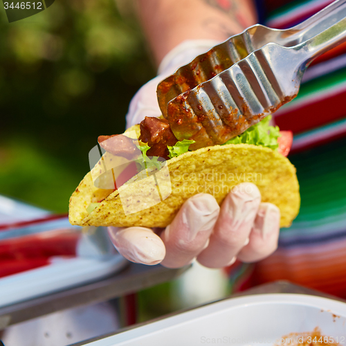 Image of Chef making tacos at a street cafe