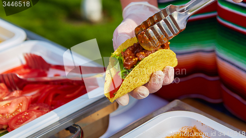 Image of Chef making tacos at a street cafe