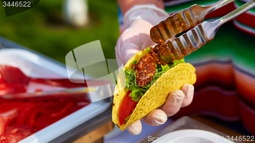 Image of Chef making tacos at a street cafe