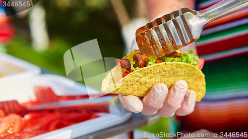 Image of Chef making tacos at a street cafe