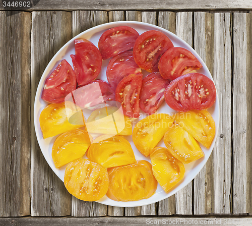 Image of Cuted red and yellow tomatoes in a plate