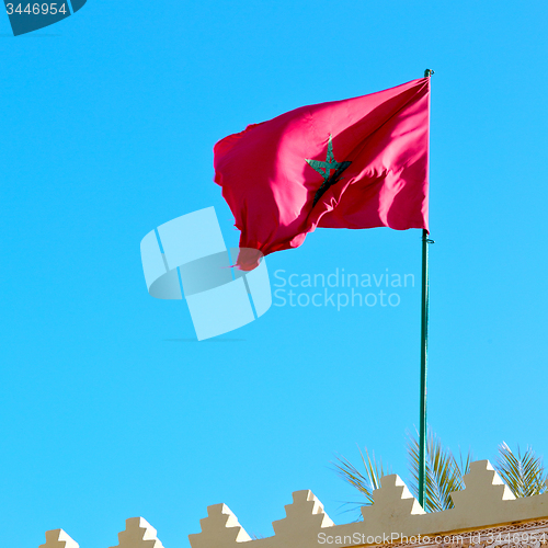 Image of tunisia  waving flag in the blue sky  colour and battlements  wa