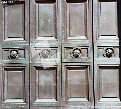 Image of in london antique brown door  rusty  brass nail and light