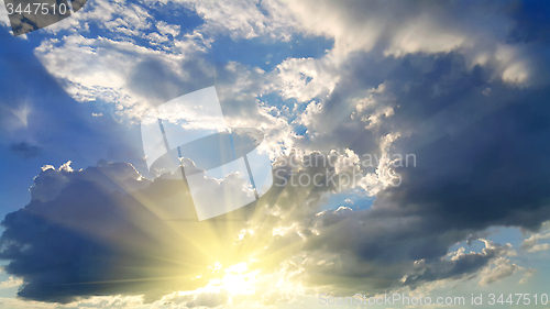 Image of Sky background with dark clouds and sunlight