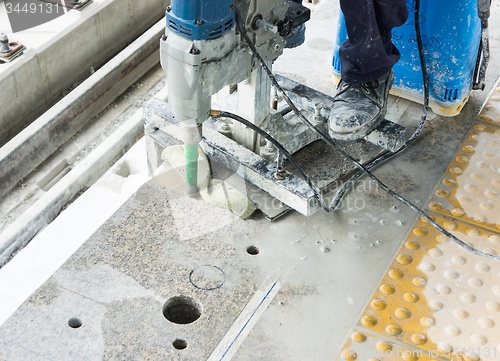 Image of Worker drilling floor