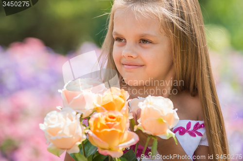 Image of Girl princess in a beautiful dress holding a bouquet of roses