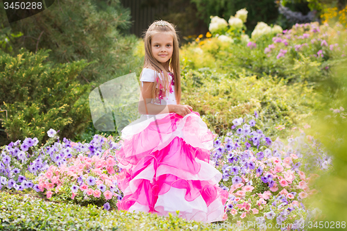 Image of Girl Princess in the garden flower bed
