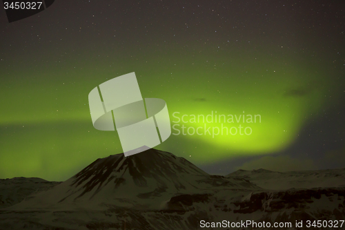 Image of Northern lights with snowy mountains in the foreground