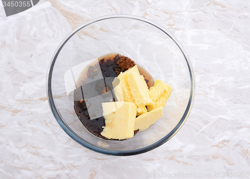 Image of Maple syrup, butter and dark soft sugar in a glass bowl