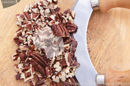 Image of Chopped toasted pecans with a rocking knife